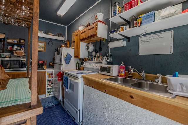 kitchen featuring sink and white appliances