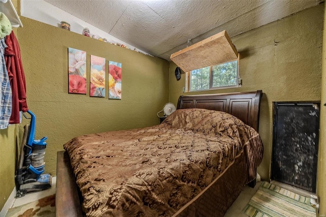 bedroom with a textured ceiling and vaulted ceiling