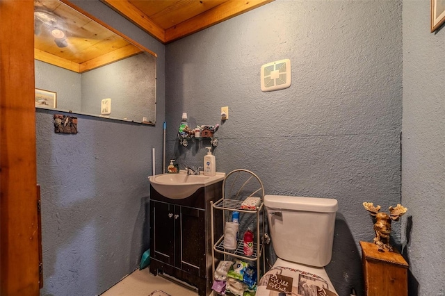 bathroom with vanity, toilet, and wooden ceiling