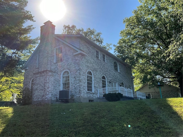 view of home's exterior featuring a yard and central AC unit