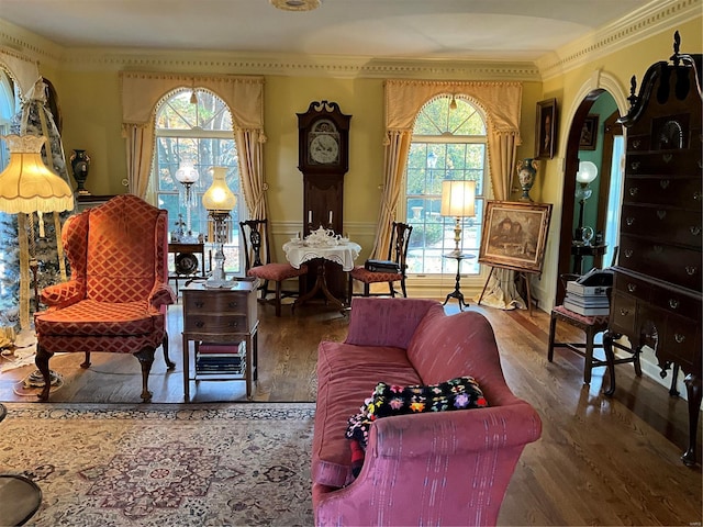 sitting room with crown molding, wood-type flooring, and plenty of natural light