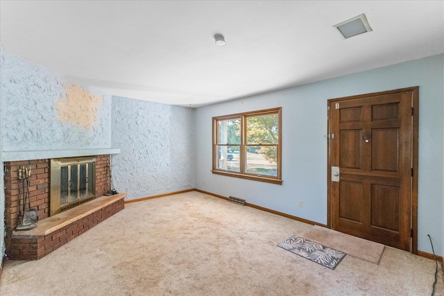 unfurnished living room with a fireplace and carpet flooring