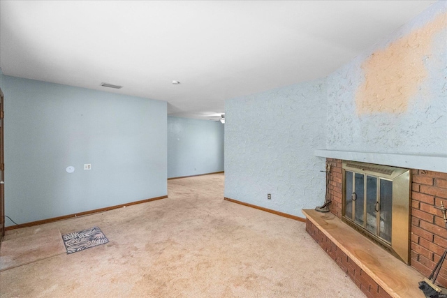 unfurnished living room with carpet floors and a brick fireplace