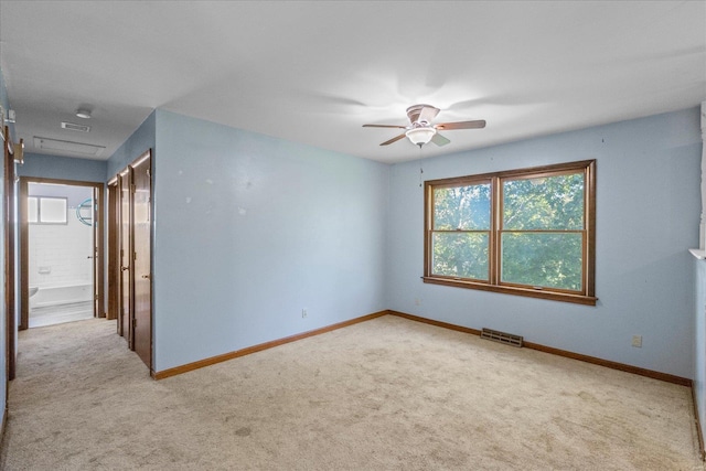 unfurnished room featuring ceiling fan and light colored carpet