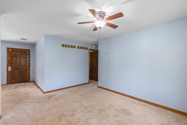 carpeted spare room with ceiling fan