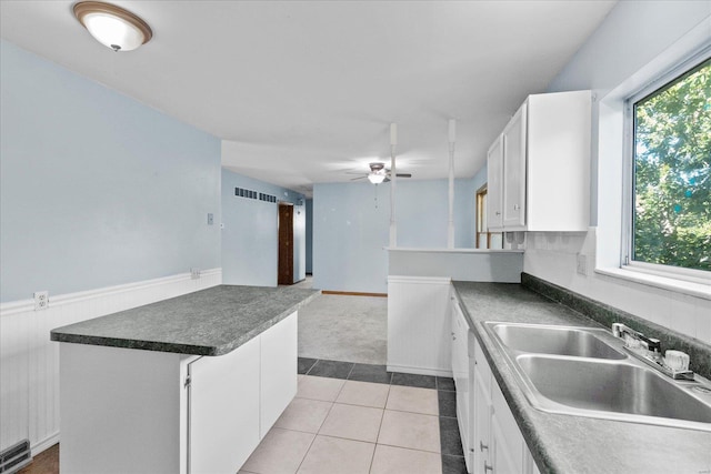 kitchen featuring light tile patterned floors, white cabinetry, ceiling fan, and a wealth of natural light