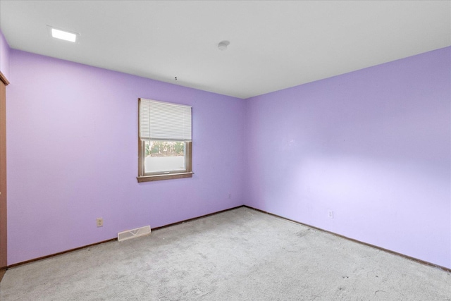 unfurnished room featuring light colored carpet