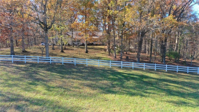 view of yard featuring fence and a rural view