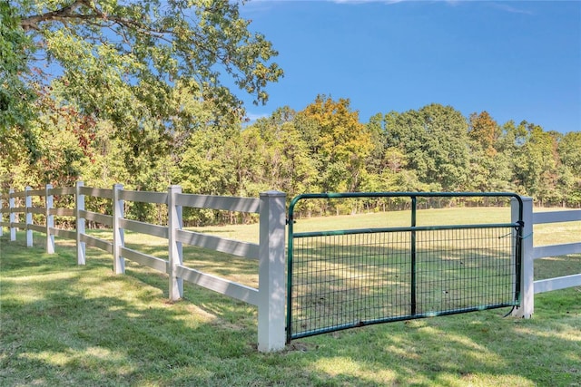 view of gate featuring fence and a lawn