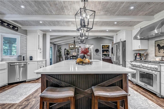 kitchen with white cabinetry, a kitchen island, a kitchen bar, and high quality appliances