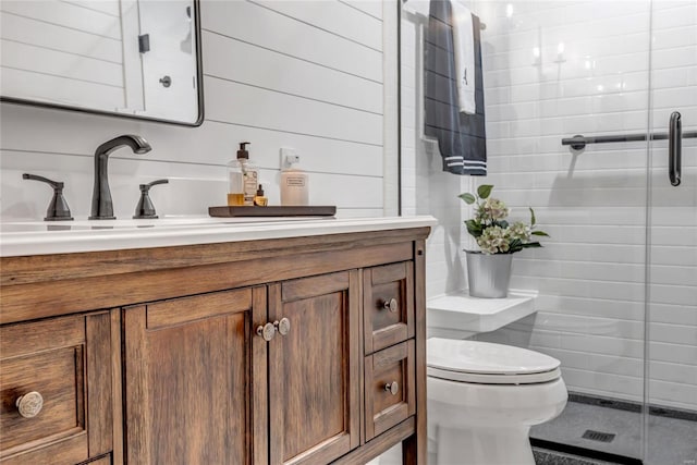 full bathroom with a shower stall, vanity, and toilet