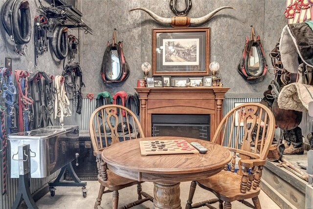 dining area with concrete floors and a fireplace