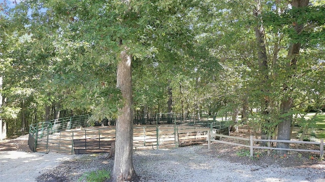 view of yard with an outbuilding, a rural view, and an exterior structure