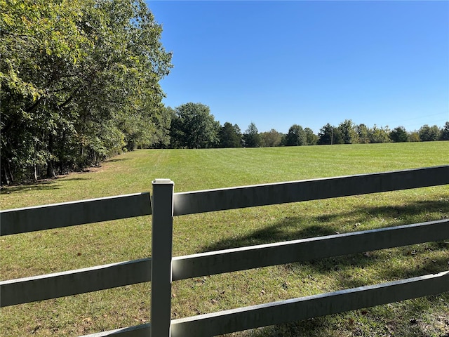 view of yard featuring a rural view and fence