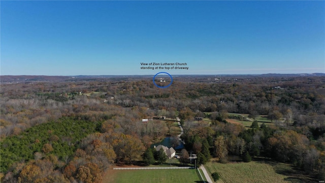 drone / aerial view featuring a forest view