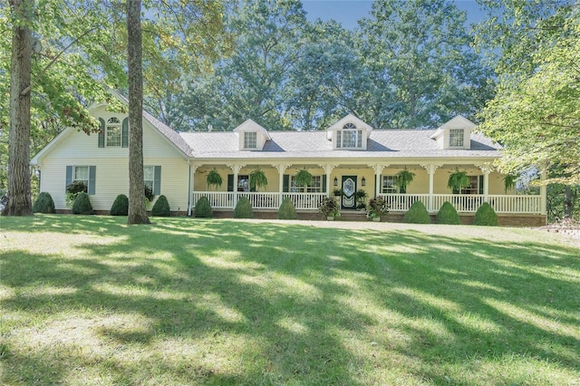 cape cod house featuring covered porch and a front yard