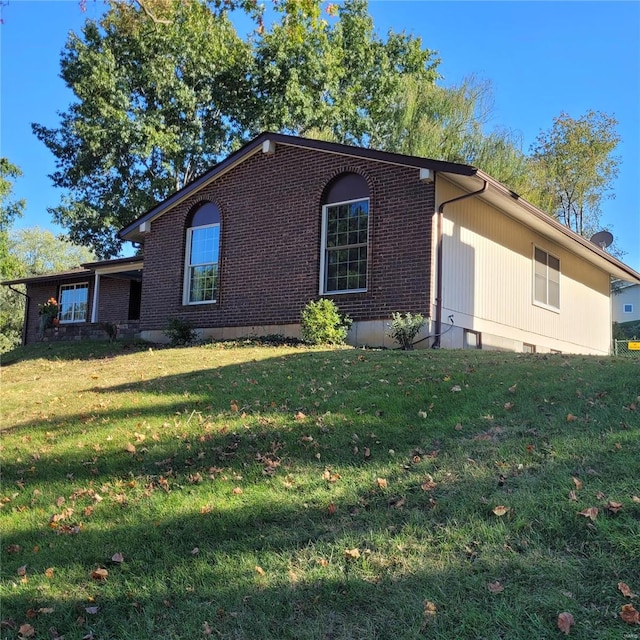 view of side of home with a lawn