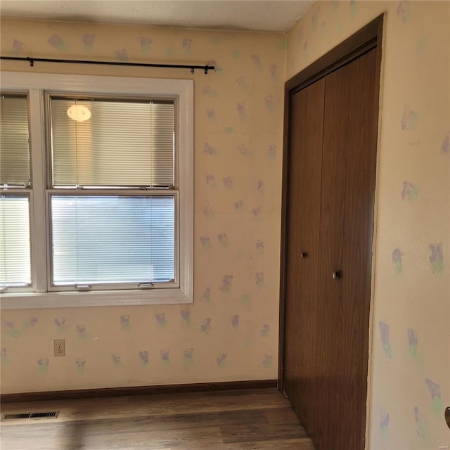 spare room with dark wood-type flooring