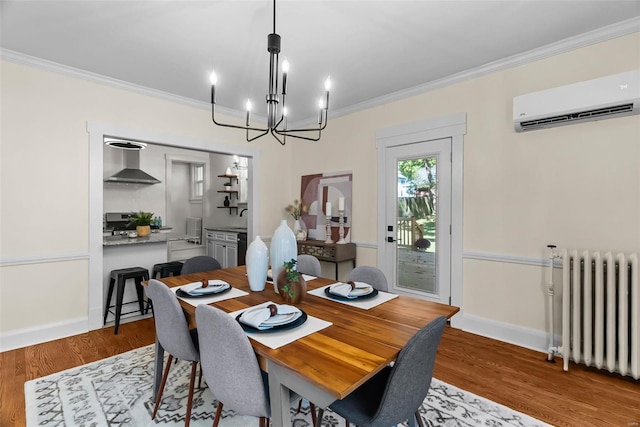 dining area featuring a wall mounted air conditioner, radiator, crown molding, an inviting chandelier, and light hardwood / wood-style flooring