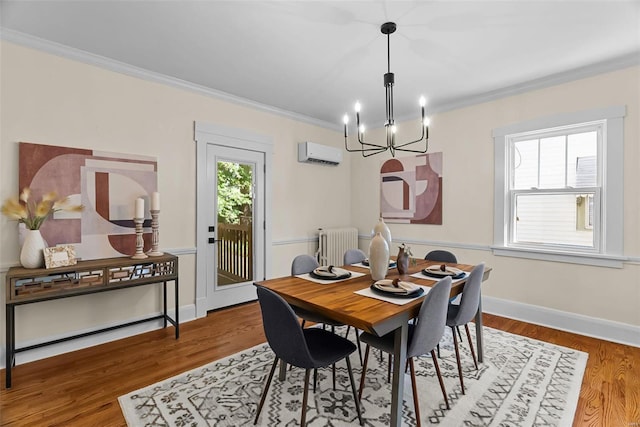 dining space featuring hardwood / wood-style floors, radiator, crown molding, a wall unit AC, and a chandelier