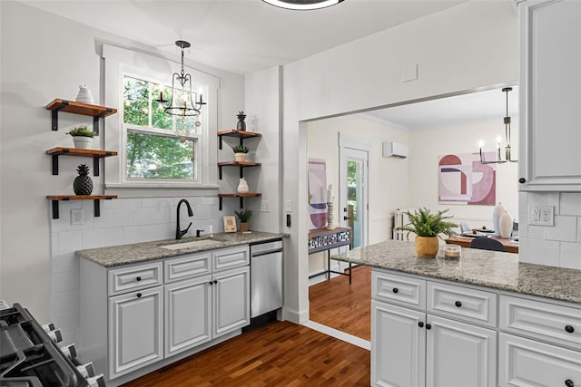 kitchen with backsplash, stainless steel dishwasher, sink, decorative light fixtures, and white cabinets