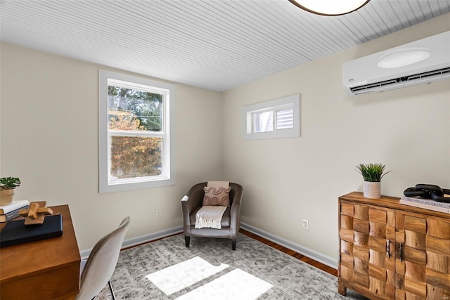 office space featuring a wall mounted AC, a wealth of natural light, and light wood-type flooring