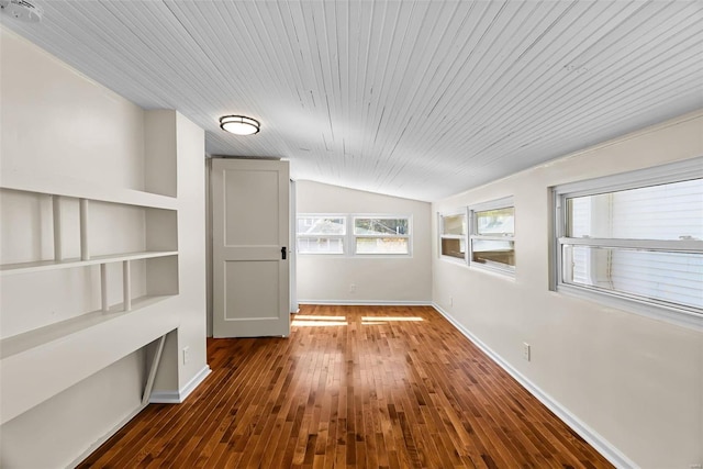 interior space featuring vaulted ceiling, built in features, dark wood-type flooring, and wood ceiling