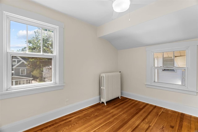 additional living space featuring radiator, ceiling fan, and hardwood / wood-style flooring