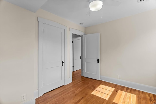 unfurnished bedroom featuring light hardwood / wood-style flooring and ceiling fan