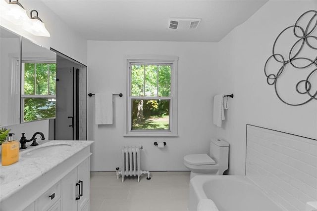 bathroom featuring vanity, radiator, tile patterned flooring, a washtub, and toilet