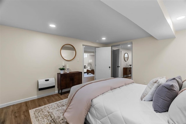 bedroom with wood-type flooring and a closet