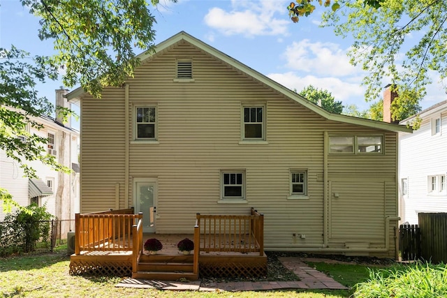 rear view of property with a wooden deck