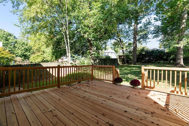 wooden terrace featuring a yard