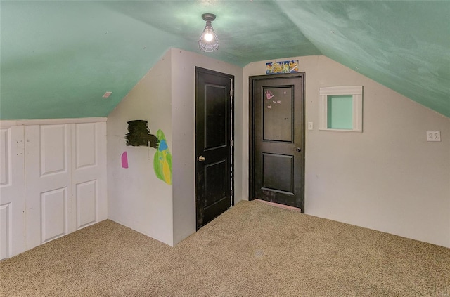 additional living space featuring lofted ceiling and carpet floors