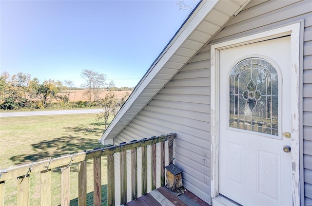 view of exterior entry with a lawn