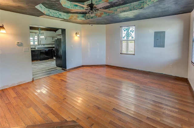 unfurnished room featuring wood-type flooring, ceiling fan, and electric panel