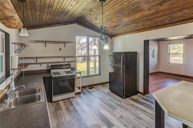 kitchen with black fridge, pendant lighting, wood ceiling, sink, and white gas range