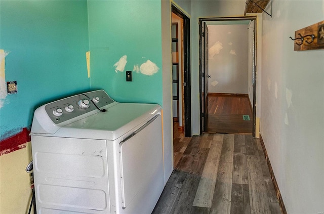 clothes washing area with dark wood-type flooring and washer and dryer