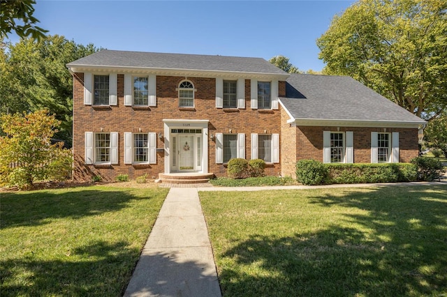 colonial-style house with a front yard