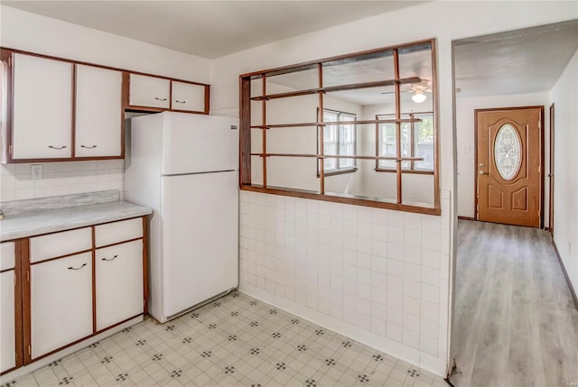 kitchen featuring white cabinetry, ceiling fan, light hardwood / wood-style flooring, and white refrigerator