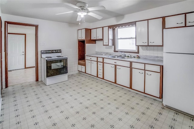 kitchen with white cabinets, sink, and white appliances