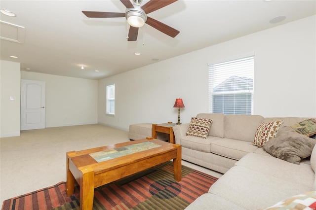 carpeted living room with ceiling fan