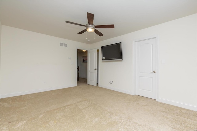 unfurnished room with light colored carpet and ceiling fan