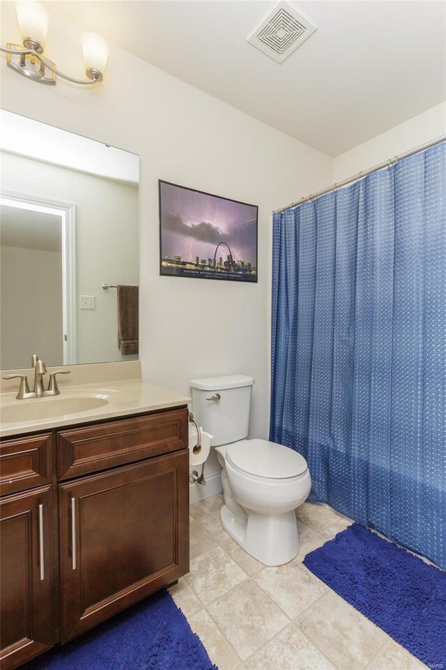 bathroom featuring vanity, a shower with curtain, tile patterned floors, and toilet