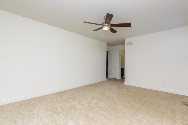 unfurnished room featuring light colored carpet and ceiling fan