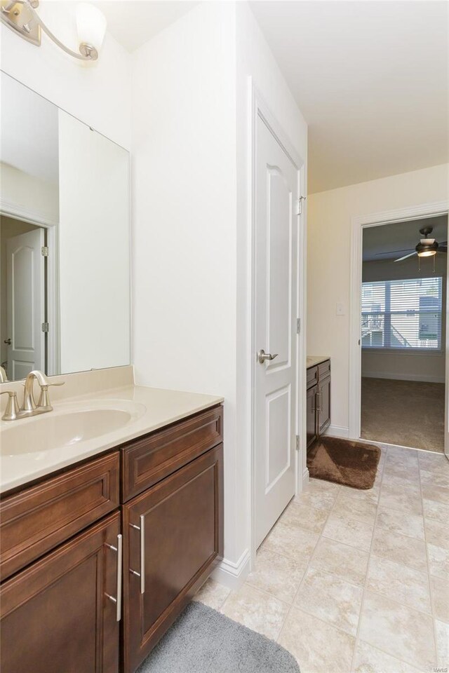 bathroom with ceiling fan and vanity