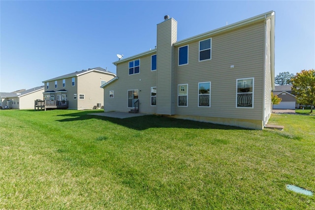 back of house with a yard and a patio area