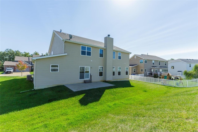 back of house featuring central AC unit, a yard, and a patio area