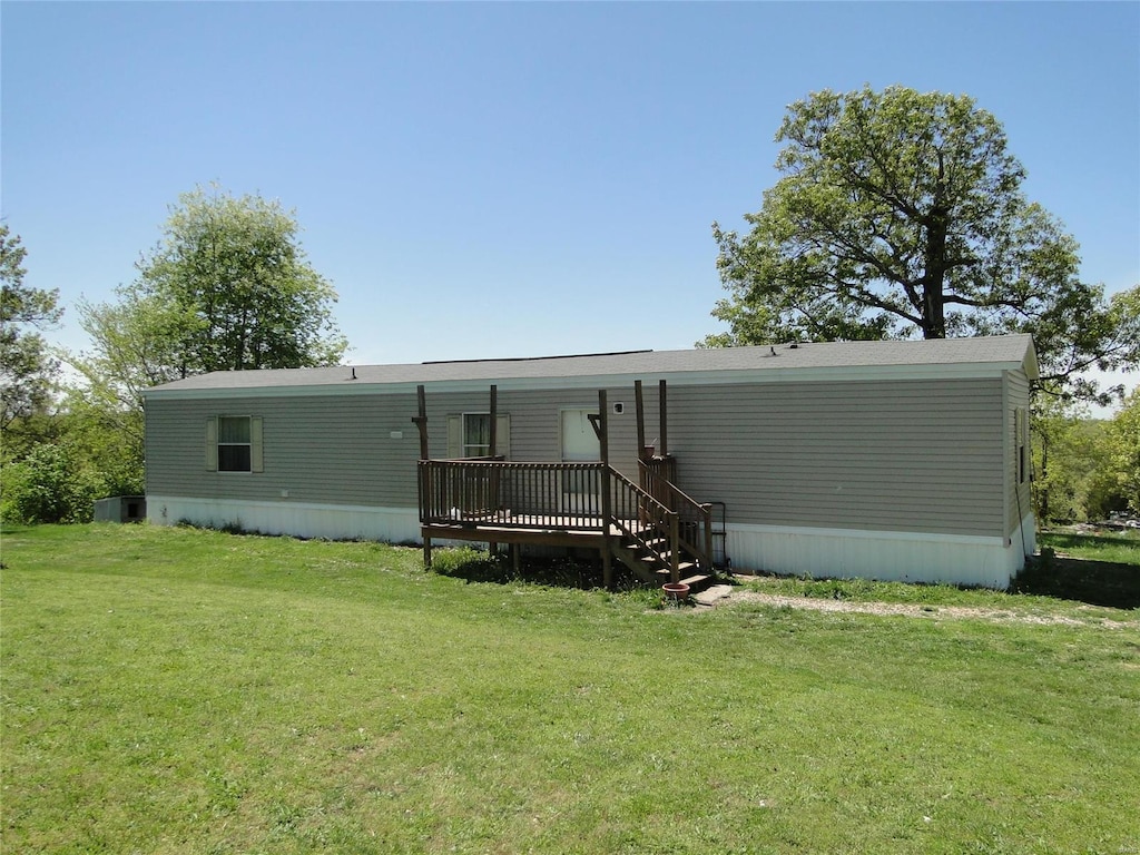 rear view of property with a lawn