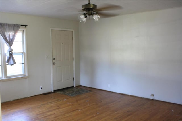 spare room with wood-type flooring, ceiling fan, and a healthy amount of sunlight